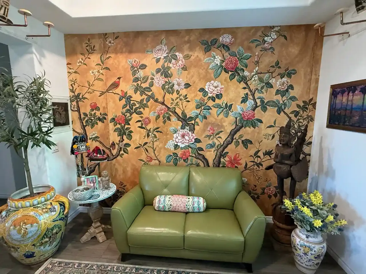 Warm botanical wallcovering across a living-room accent wall